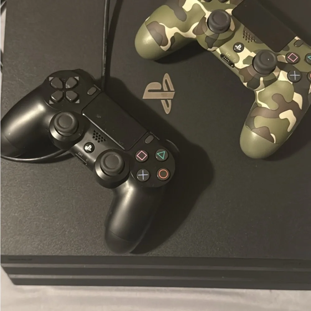 Sony Console with Black and Camouflage Controllers